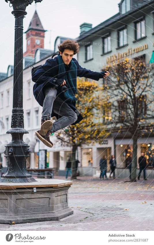 Young man jumping on street Man handsome City Street Jump Joy Happy Trick performing Youth (Young adults) Town Lifestyle Easygoing Fashion Style Adults Modern