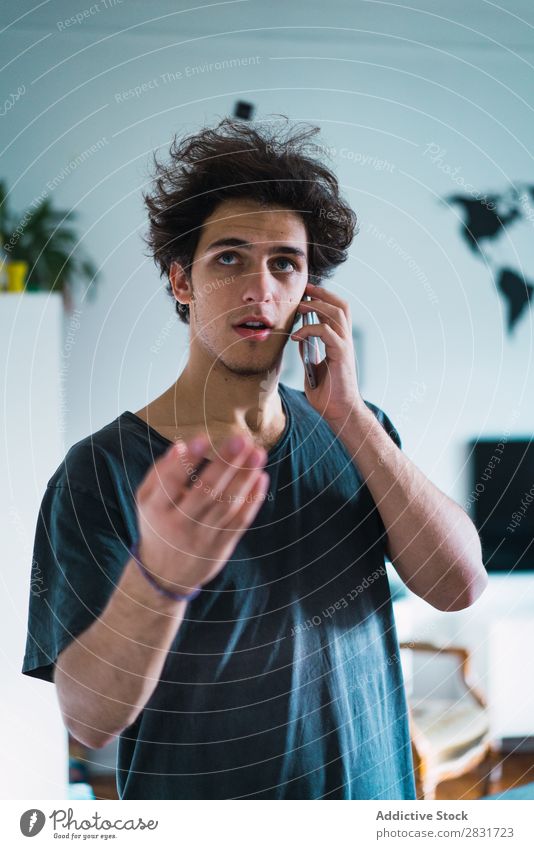 Man talking on phone at home handsome Home To talk PDA Stand Communication Gadget device Youth (Young adults) Portrait photograph Lifestyle Human being