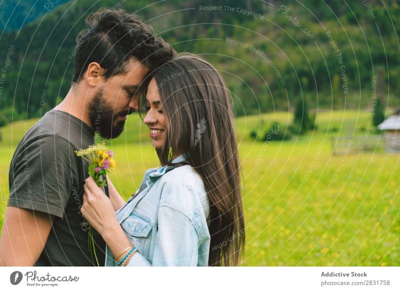 Couple cuddling on meadow Meadow Hill Cuddling Flower bunch Small Nature Summer Human being Man Woman Love Grass Beautiful Together Youth (Young adults) Happy