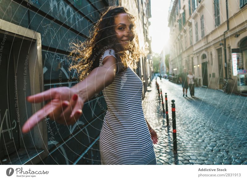 Cheerful traveler posing at street Woman Street Happiness romantic Summer Town spinning round waving hair Beautiful Posture in motion To enjoy Model Feminine