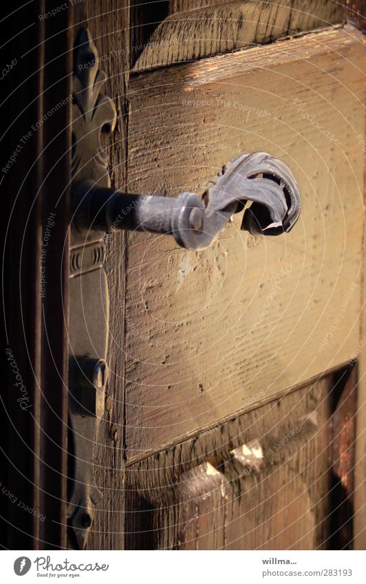 Old curved door handle Curved Wooden door nostalgically Door handle Historic Brown Nostalgia Metal fitting Ornate Keyhole Texture of wood Entrance Brass