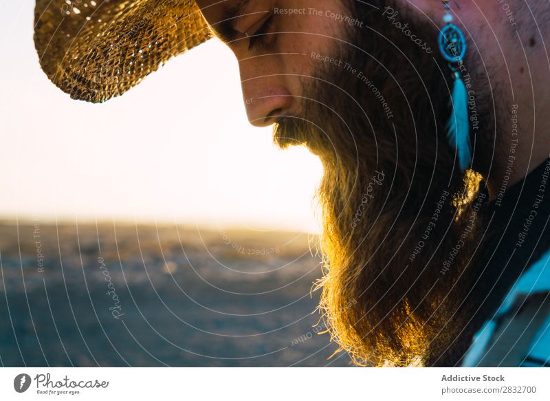 Bearded man in hat against sunlight Man bearded Cowboy Style Sunlight Self-confident Nature Portrait photograph Hat Countries Masculine Earnest Straw hat outfit