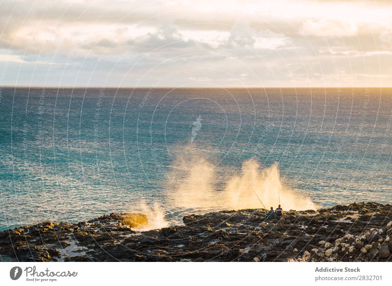 People fishing on shoreline of ocean Ocean Coast Fishery Landscape Infinity Rock Vacation & Travel Relaxation seaside seascape Nature marine Water Splashing