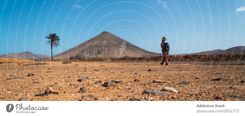 Man with backpack walking in tropical desert traveler Desert trekking Freedom terrain Traveling Seasons Adventure exploration Dune Walking Tourism Natural