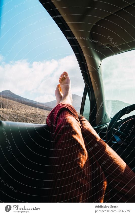 Crop man relaxing in car while traveling Man Car Landscape Window Feet Relaxation Transport Freedom Barefoot Legs Adventure Leisure and hobbies Stick out Lounge