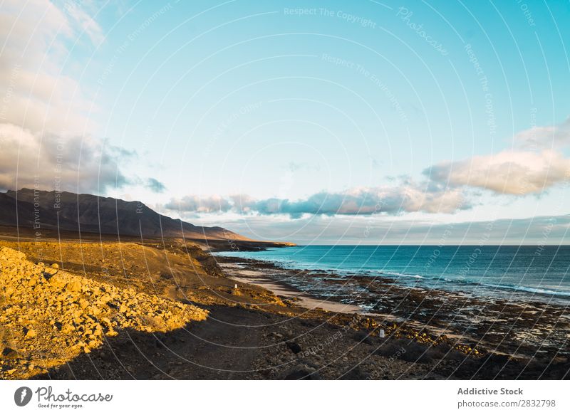 View of shoreline of ocean Coast Panorama (Format) Ocean Pebble Scene Wild Peaceful Landscape seascape Beach Remote Clouds Sky Tourism Natural scenery seaside