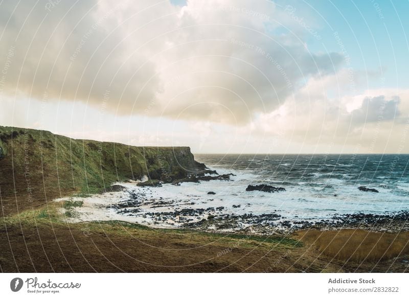 Coastal rocks and wavy ocean seaside Rock Ocean Landscape Beach Nature Water Natural seascape Stone Beautiful Northern Ireland Vacation & Travel Sunbeam Cliff