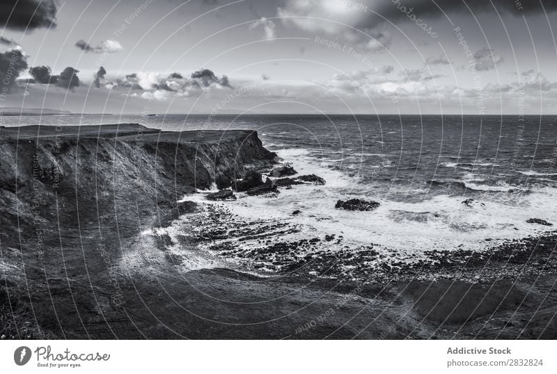 BW shot of rocky coast Coast seaside Rock Ocean Landscape Beach Nature Water Natural seascape Stone Beautiful Grass Northern Ireland Vacation & Travel Sunbeam