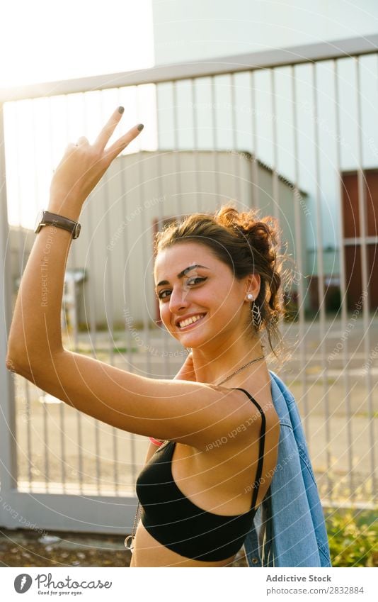 Trendy cheerful girl gesturing at street Woman Style Street two fingers Portrait photograph Youth (Young adults) Vacation & Travel Happiness Gesture Expression