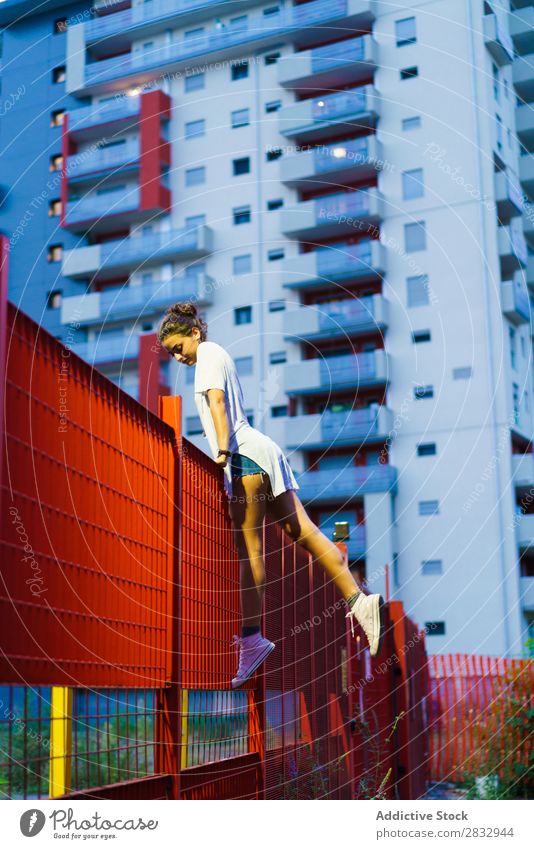 Girl balancing on fence Woman Fence Balance Town Posture Youth (Young adults) sportswoman Self-confident youngster Athletic Sports Evening Body Exterior shot