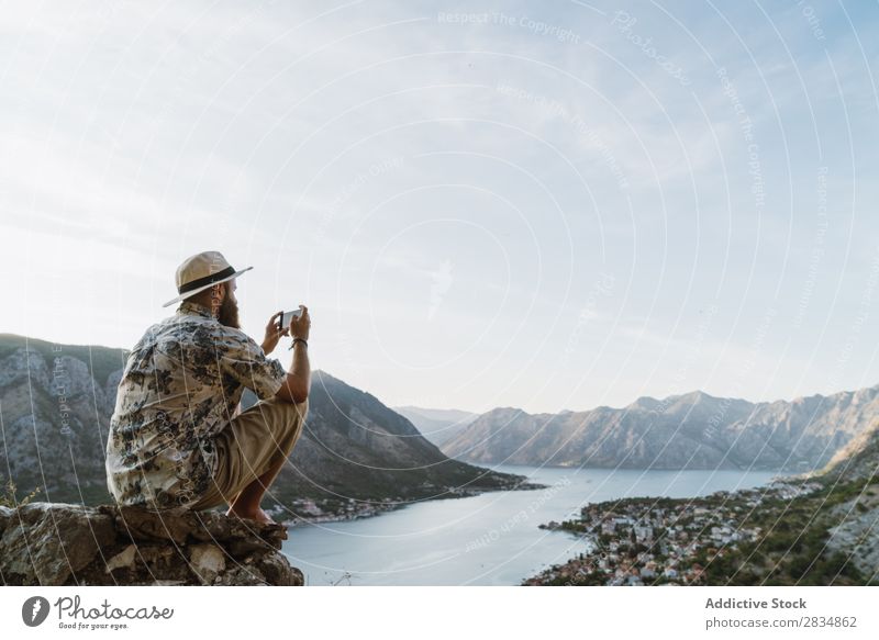 Man taking shots of town Town Mountain River Human being Take Tourist Village Vantage point pathway Landscape Vacation & Travel Nature Tourism Beautiful Valley