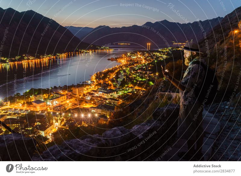 Man on mountain at town Town Mountain River Human being Tourist Village Vantage point pathway Landscape Vacation & Travel Nature Tourism Evening Night