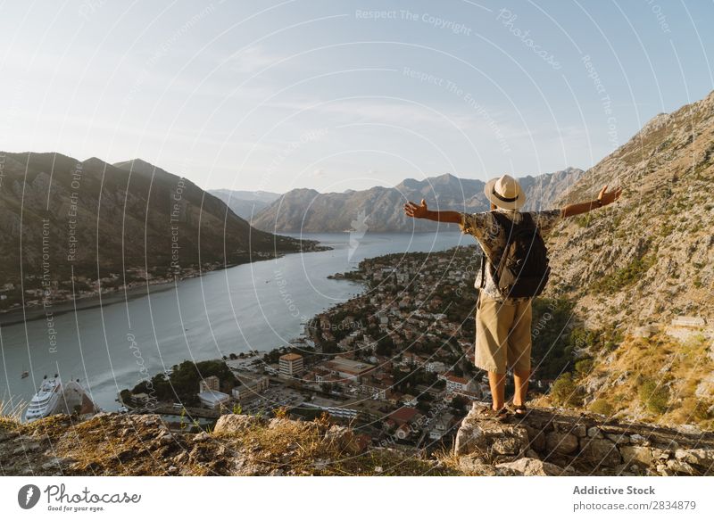 Tourist looking at riverside town Town Mountain River Man Human being Village Vantage point pathway Landscape Vacation & Travel Nature Tourism Beautiful Valley