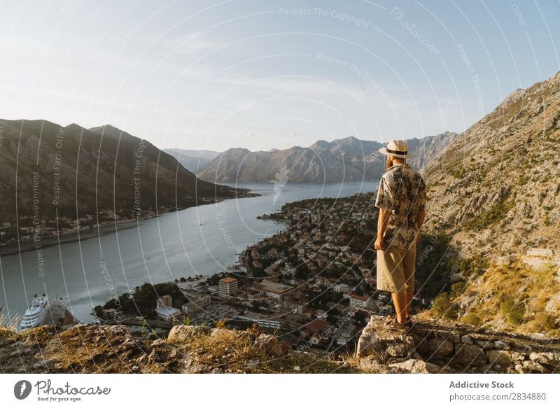 Tourist looking at riverside town Town Mountain River Man Human being Village Vantage point pathway Landscape Vacation & Travel Nature Tourism Beautiful Valley