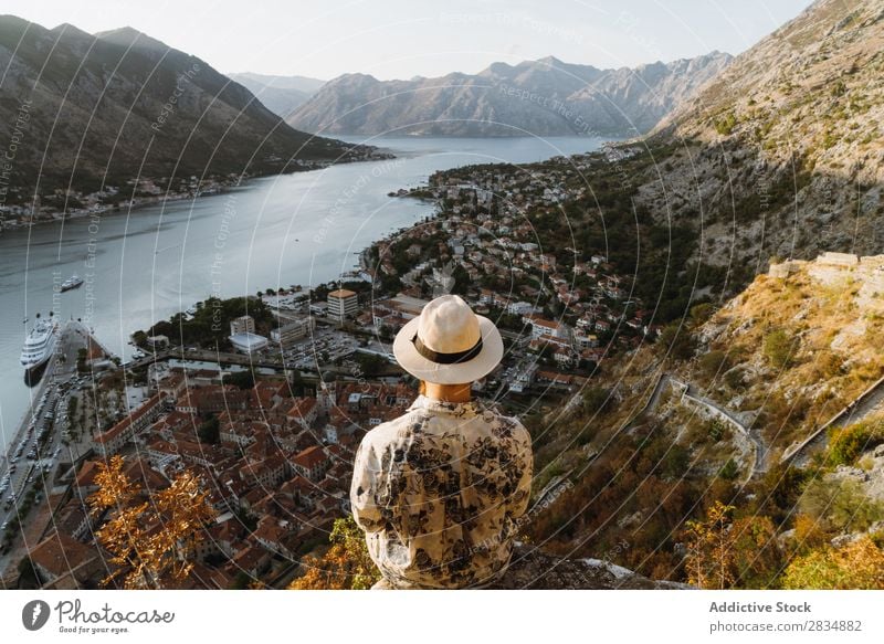 Tourist looking at riverside town Town Mountain River Man Human being Village Vantage point pathway Landscape Vacation & Travel Nature Tourism Beautiful Valley