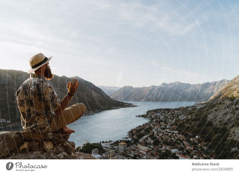 Man meditating phone in mountains Town Mountain River Human being Tourist Village Vantage point pathway Landscape Vacation & Travel Nature Tourism Beautiful