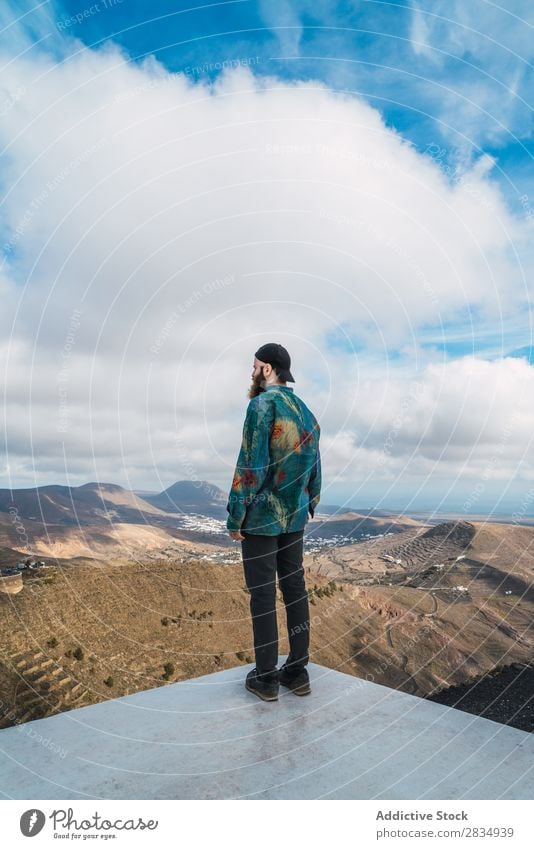 Man on mountain viewpoint Tourist Mountain Clouds Nature Landscape Natural Rock Stone Lanzarote Spain Vantage point Vacation & Travel bearded Tourism Trip