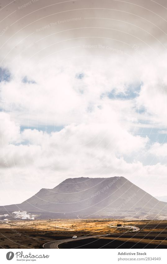 Road to mount in cloudy day Mountain Clouds Street Motor vehicle Nature Landscape Natural Rock Stone Lanzarote Spain Vantage point Vacation & Travel Car Tourism