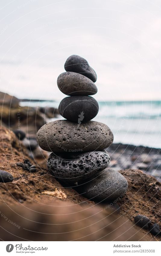 Stacked stones on shore Coast Stone Nature Landscape Zen Tower Natural Rock Lanzarote Spain Vantage point Vacation & Travel Clouds Tourism Trip Hill tranquil