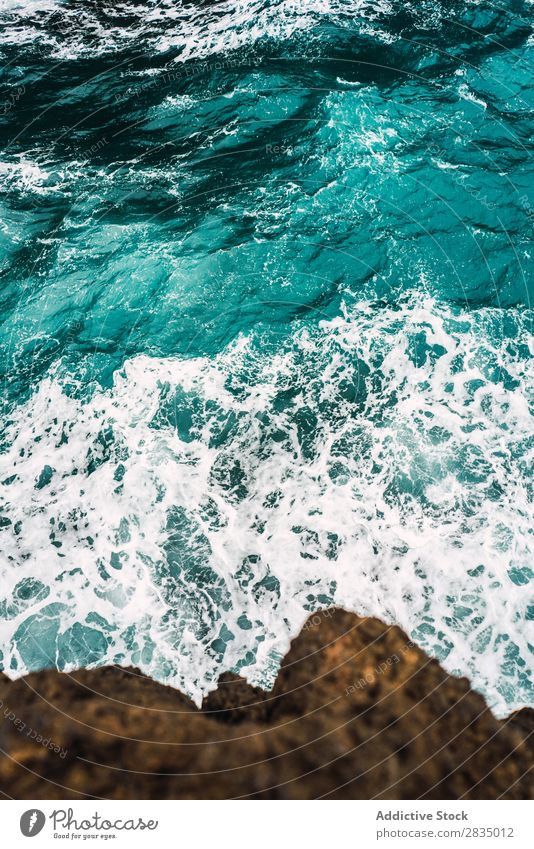 Turquoise ocean and rock Water Ocean Nature Landscape Cliff coastal Coast Natural Rock Stone Lanzarote Spain Vantage point wavy Vacation & Travel Tourism Trip