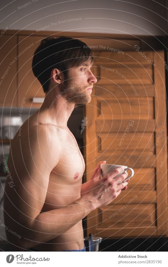 Shirtless man with a cup Man Cup Morning Considerate Looking away Pensive Mug Hot Drinking sleepy Think Breakfast Lifestyle Home Portrait photograph Kitchen