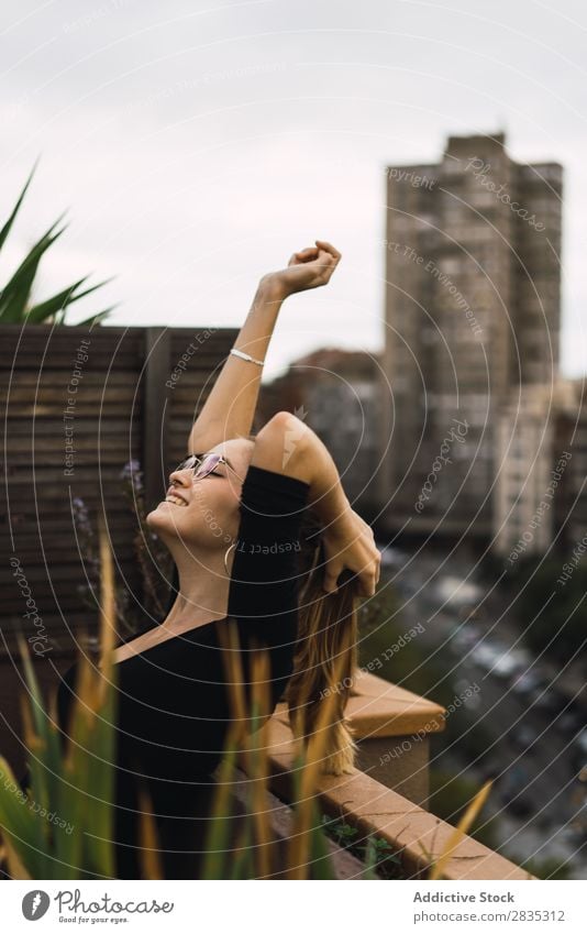 Young content model on terrace Woman Happiness Posture Terrace Cheerful Self-confident To enjoy Relaxation Leisure and hobbies Freedom Summer Fresh Action Calm