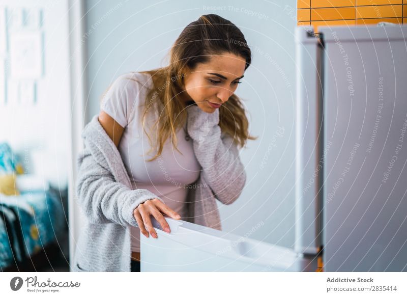 Pretty woman at opened fridge Woman pretty Home Youth (Young adults) Take refrigerator Opening Posture Portrait photograph Beautiful Lifestyle