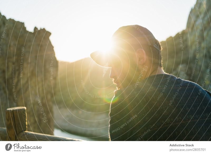 Confident man on rocky terrace Man traveler Relaxation Cliff Panorama (Format) Posture Self-confident Wanderlust Sunlight Masculine Vacation & Travel Fresh