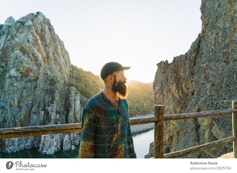 Confident man on rocky terrace Man traveler Relaxation Cliff Panorama (Format) Posture Self-confident Wanderlust Sunlight Masculine Vacation & Travel Fresh