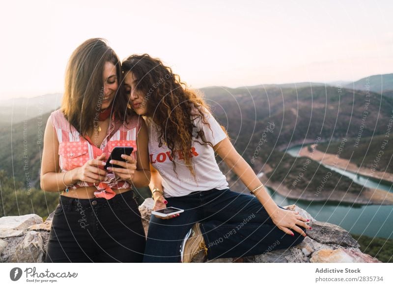 Stylish women browsing phone on breathtaking landscape Woman Nature Mountain Point in time Cheerful Panorama (Format) Summer PDA Wanderlust having fun Posture