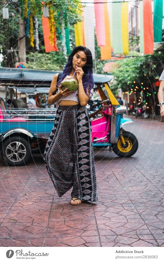 Young woman with coconut drink on street Woman pretty Street Youth (Young adults) Beautiful Portrait photograph Stand Coconut Drinking Straw Hair Purple asian