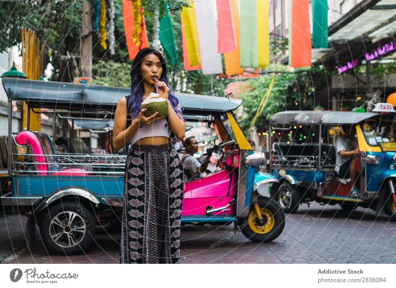 Young woman with coconut drink on street Woman pretty Street Youth (Young adults) Beautiful Portrait photograph Stand Coconut Drinking Straw Hair Purple asian