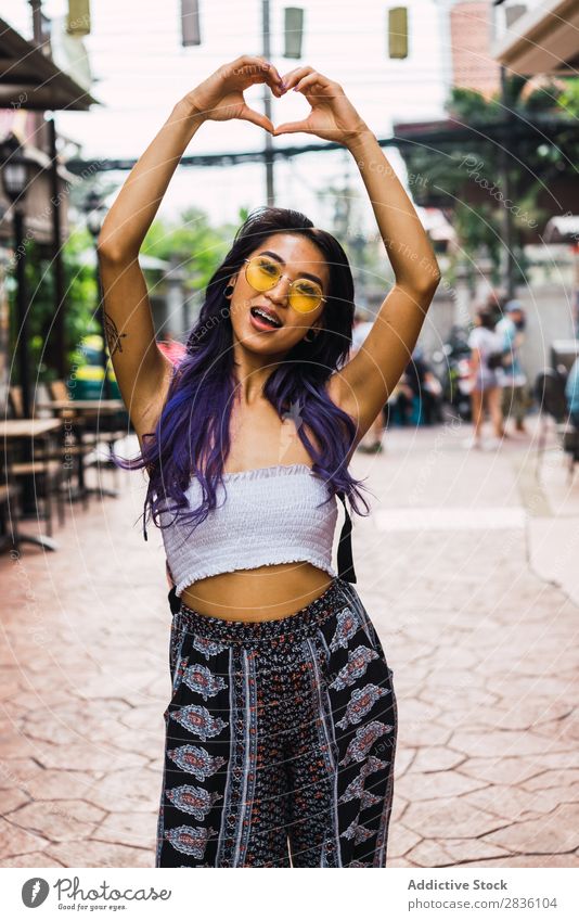 Woman gesturing heart on street pretty Street Youth (Young adults) Beautiful Heart Hands up! shoving Love Symbols and metaphors Portrait photograph Hair Purple