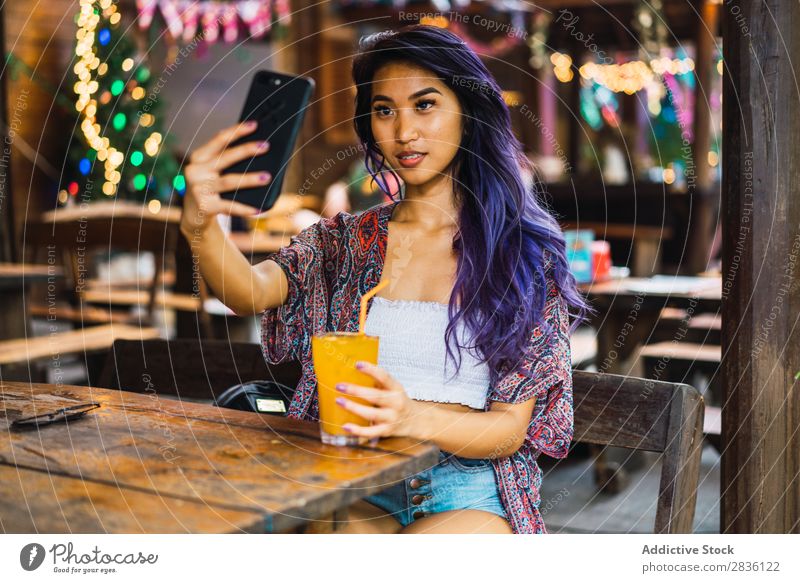 Woman with smartphone in cafe pretty Youth (Young adults) Beautiful Portrait photograph Juice Drinking PDA using browsing Café Hair Purple asian eastern Fashion