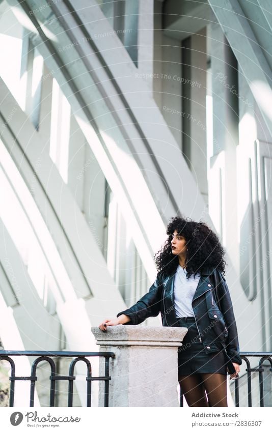 Stylish woman posing at fence Woman Attractive City fashionable Curly Brunette Fence Column Street Fashion Youth (Young adults) Beautiful pretty Model Style