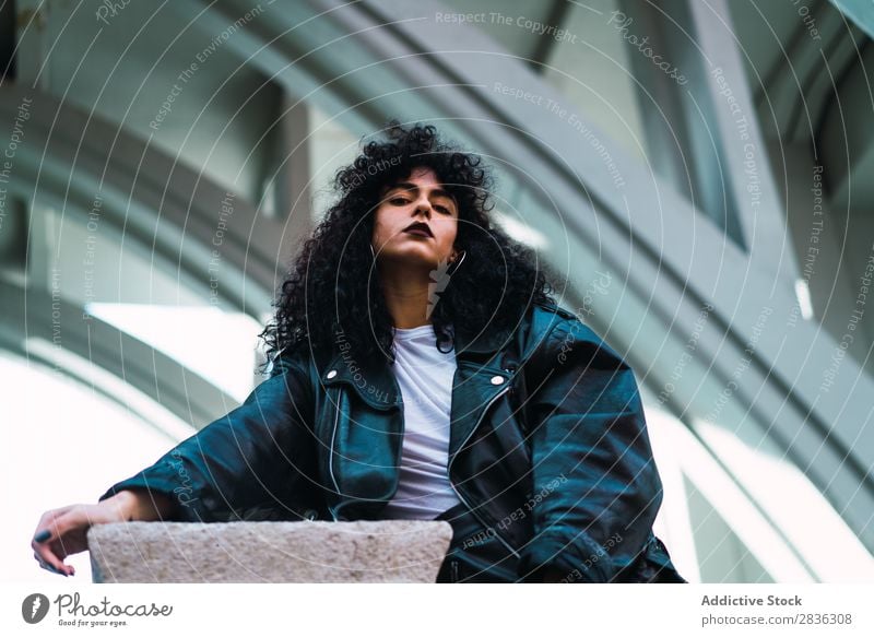 Stylish woman posing at fence Woman Attractive City fashionable Curly Brunette Fence Column Street Fashion Youth (Young adults) Beautiful pretty Model Style