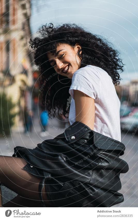 Curly woman posing in city Woman Attractive City fashionable Brunette Jacket Fence Fashion Youth (Young adults) Beautiful pretty Street Model Style Hair