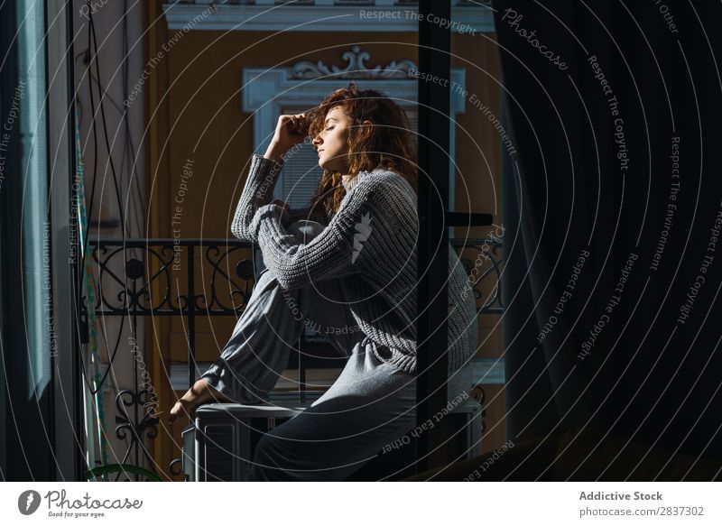 Young woman posing on balcony Woman Home pretty Balcony Relaxation Sit eyes closed Youth (Young adults) Posture Portrait photograph Beautiful Lifestyle