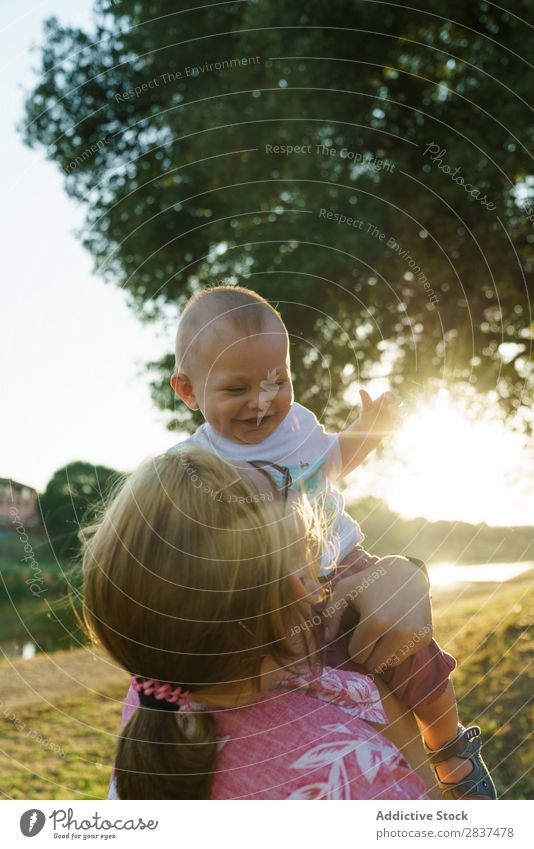 Mother with child in park Child Park Lawn Green Sunbeam Family & Relations Happy Human being Woman Happiness Summer Lifestyle Love Parents Nature