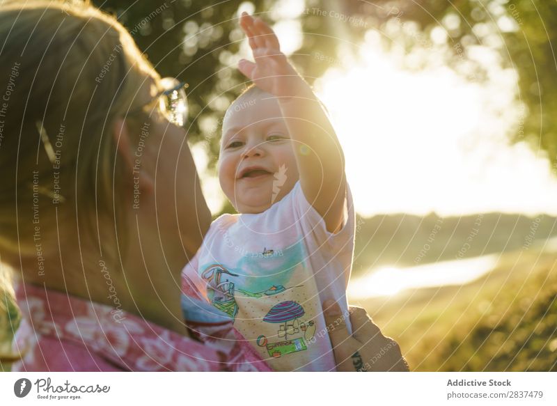 Mother with child in park Child Park Lawn Green Sunbeam Family & Relations Happy Human being Woman Happiness Summer Lifestyle Love Parents Nature