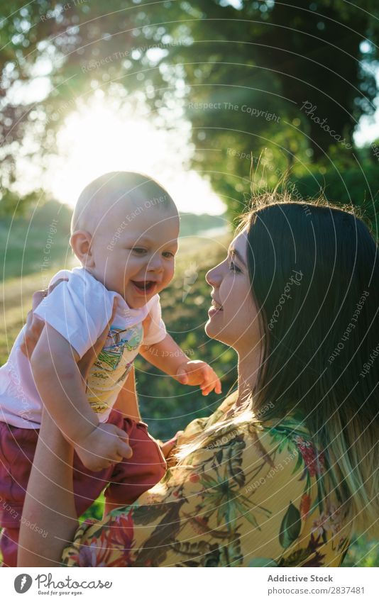 Mother with child in park Child Park Lawn Green Sunbeam Family & Relations Happy Human being Woman Happiness Summer Lifestyle Love Parents Nature