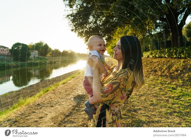 Mother with child in park Child Park Lawn Green Sunbeam Family & Relations Happy Human being Woman Happiness Summer Lifestyle Love Parents Nature