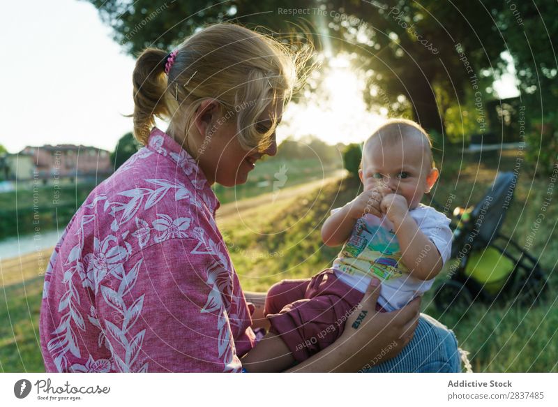 Mother with child in park Child Park Lawn Green Sunbeam Family & Relations Happy Human being Woman Happiness Summer Lifestyle Love Parents Nature