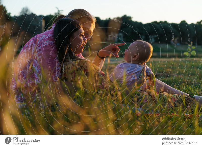 Happy lesbian family with child Mother Child Park Lawn Green Sunbeam Human being Woman Happiness Summer Lifestyle Love same gender parents Homosexual Couple