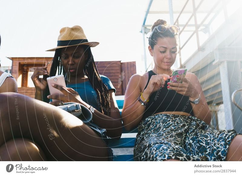 Friends with smart phones relaxing outside Human being Friendship Relaxation PDA Share Traveling Terrace Cheerful Technology Happiness Communication gathering