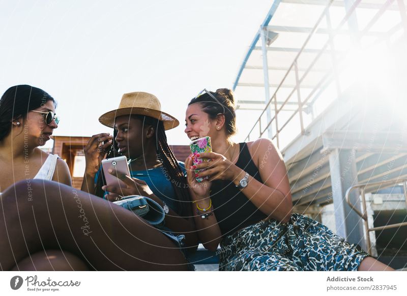 Friends with smart phones relaxing outside Human being Friendship Relaxation PDA Share Traveling Terrace Cheerful Technology Happiness Communication gathering