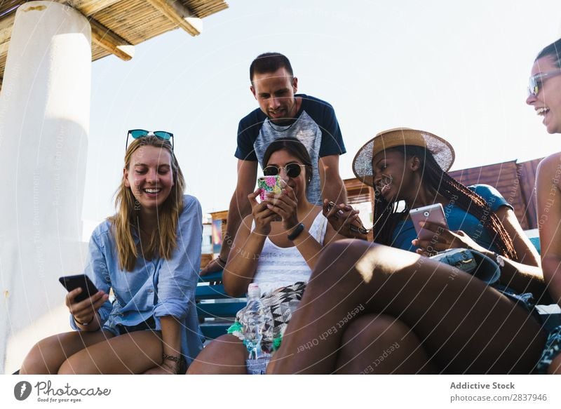 Friends with smart phones relaxing outside Human being Friendship Relaxation PDA Share Traveling Terrace Cheerful Technology Happiness Communication gathering