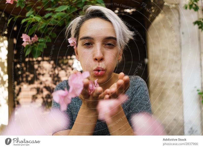 Woman blowing petals from hands Flower Street Blossom leave Blow Looking into the camera Beautiful romantic Spring Girl Summer Floral Sunbeam Happy Pink Cute