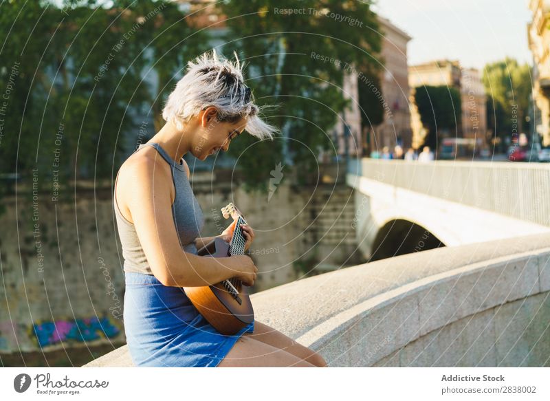 Girl playing small guitar at street Woman Street Entertainment Ukulele Musician City Lifestyle Style Summer Leisure and hobbies Beauty Photography Uniqueness