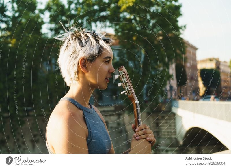 Girl playing small guitar at street Woman Street Entertainment Ukulele Musician City Lifestyle Style Summer Leisure and hobbies Beauty Photography Uniqueness